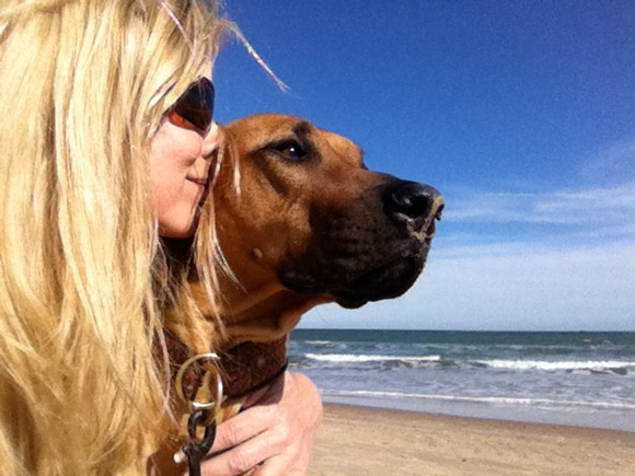Founder of Go Travel Dog on the beach with her dog
